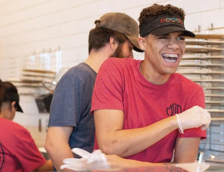 A MOD squad member smiling while working at MOD.