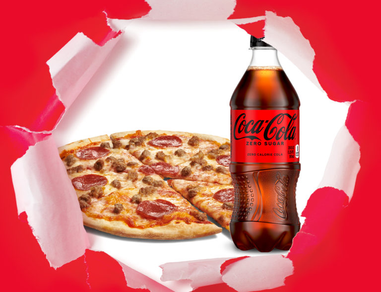Mad dog pizza with pepperoni, ground beef, and mild sausage and a Coke bottled beverage.