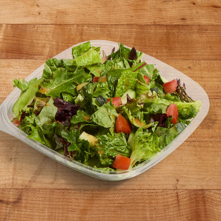 A garden salad on a wood tabletop.